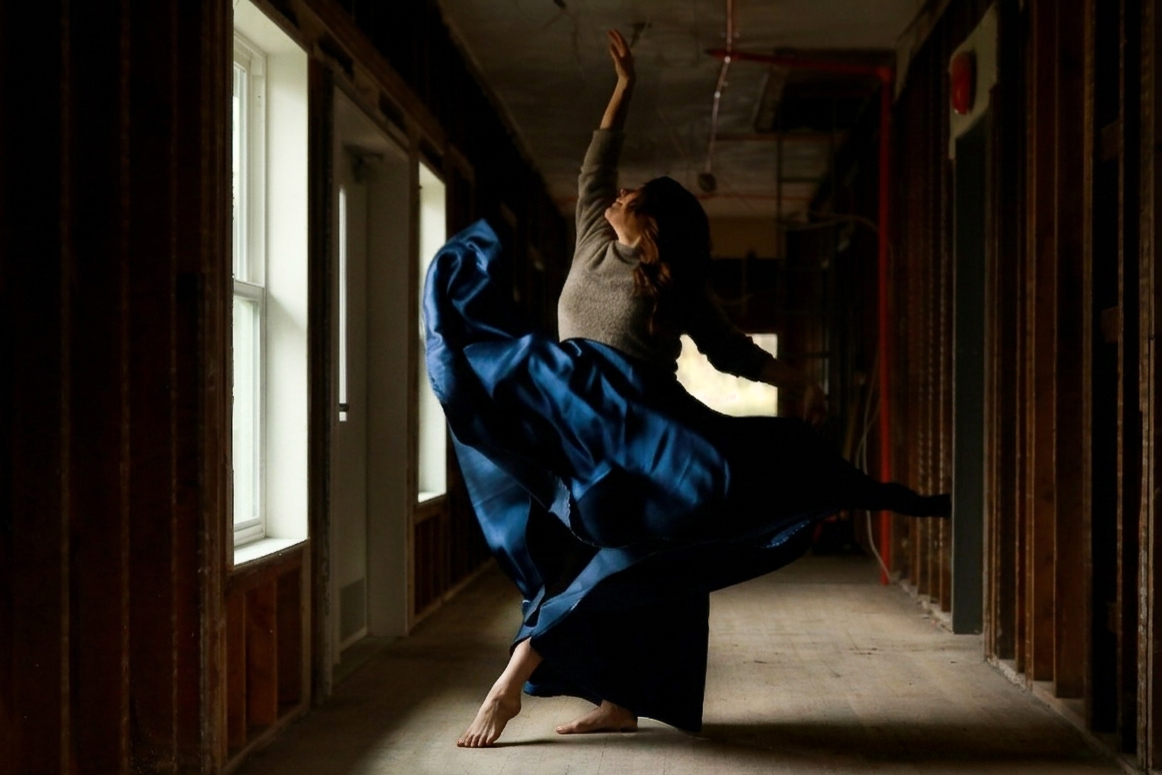 A dancer mid-movement in the historic lodge