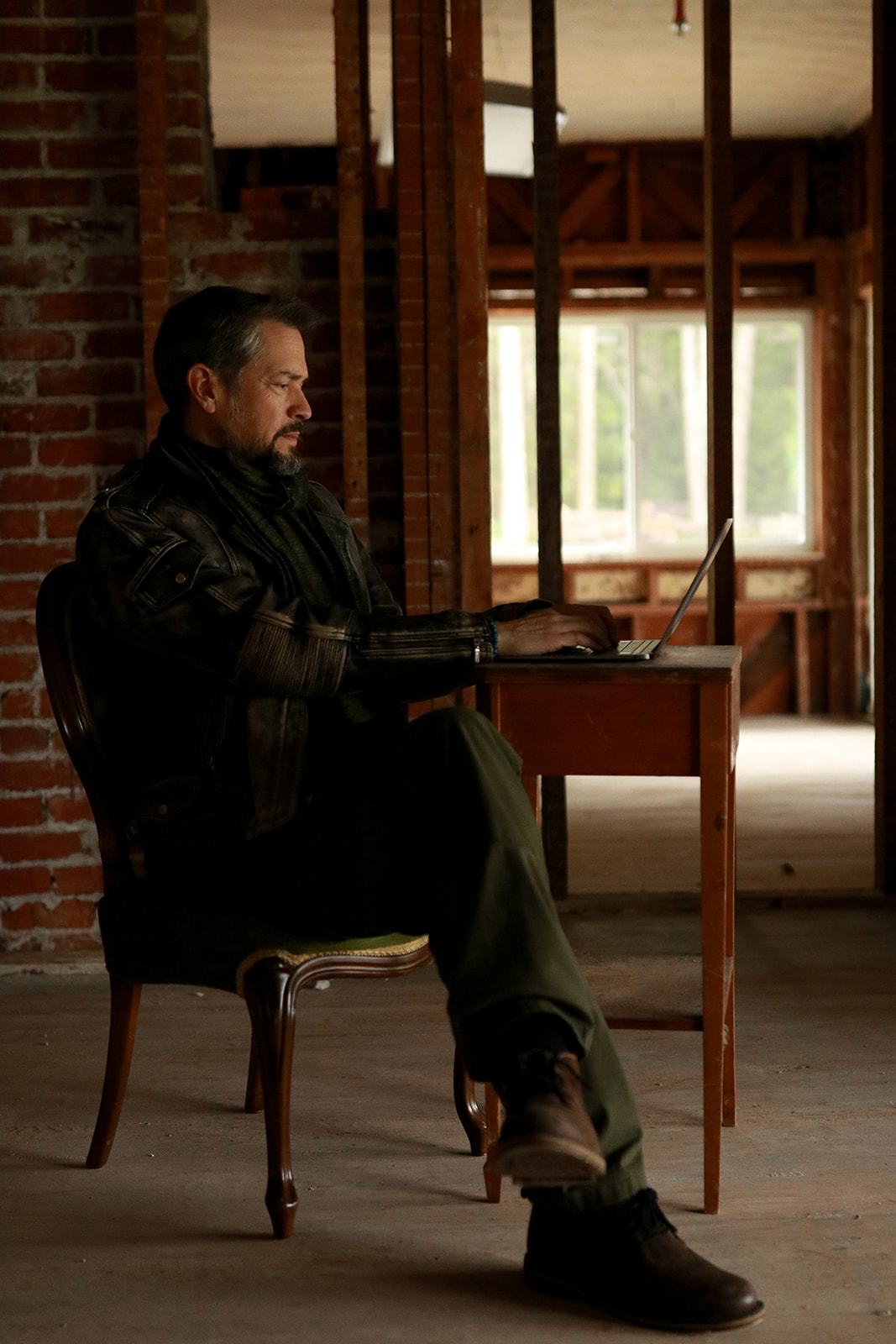 A creator working on a laptop in the lodge
