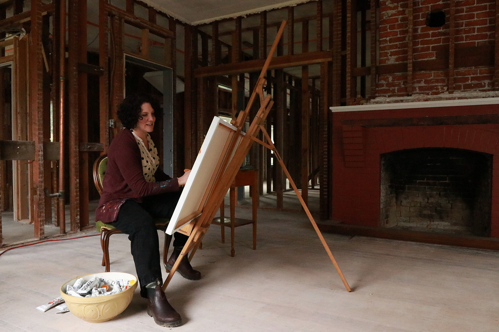 A painter at work at an easel in the lodge